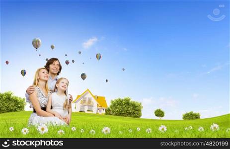 Happy family. Happy family of mother father and daughter sitting on grass