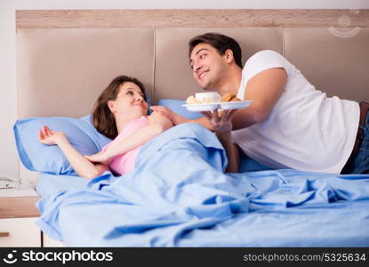 Happy family having breakfast in bed