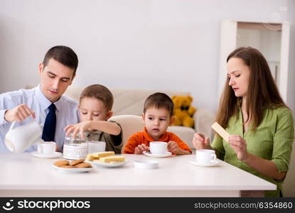 Happy family having breakfast together at home