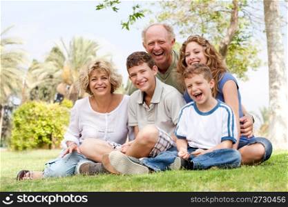 Happy family having fun in the park, smiling and enjoying sunny day