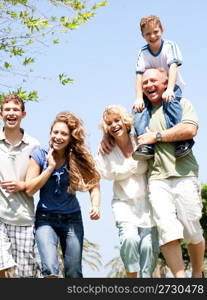 Happy family having fun in the park with three children