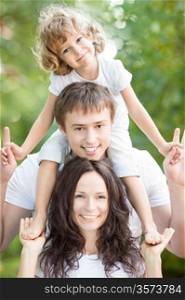 Happy family having fun outdoors against spring green background