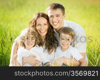 Happy family having fun outdoors in spring green field