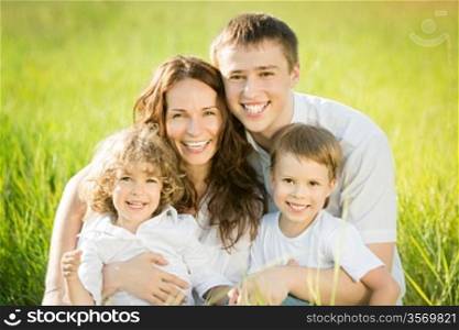 Happy family having fun outdoors in spring green field