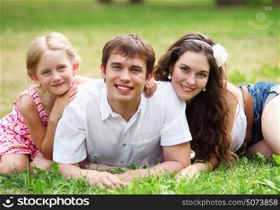 happy family having fun outdoors. Young Family Outdoors Walking Through Park in summer
