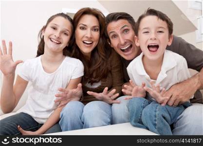 Happy Family Having Fun Sitting Laughing At Home