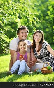 Happy family having picnic in summer park