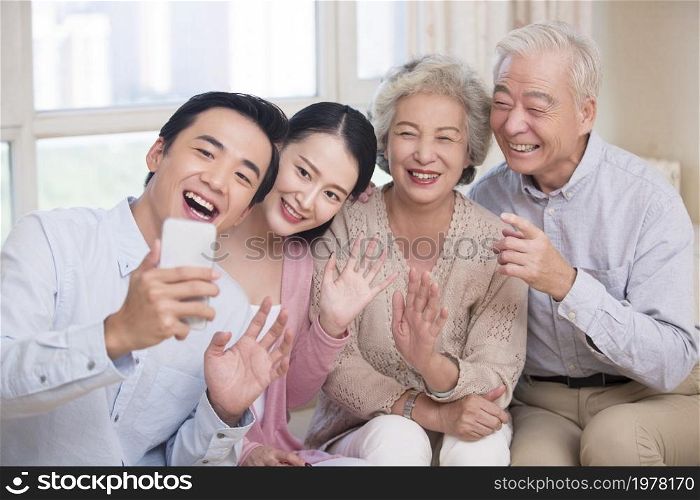 Happy family having video call on their cell phone