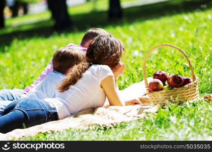 Happy family having weekend in summer park. Picnic in garden