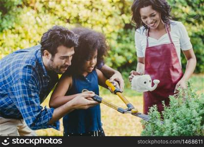 Happy family holiday activity during stay at home parent at backyard gardening with children.