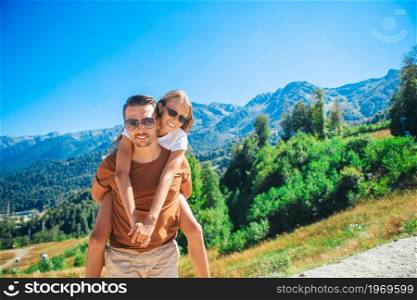 Happy family in mountains on summer vacation. Beautiful happy family in mountains in the background of fog