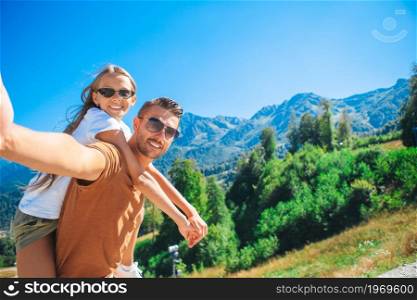 Happy family in mountains on summer vacation. Beautiful happy family in mountains in the background of fog