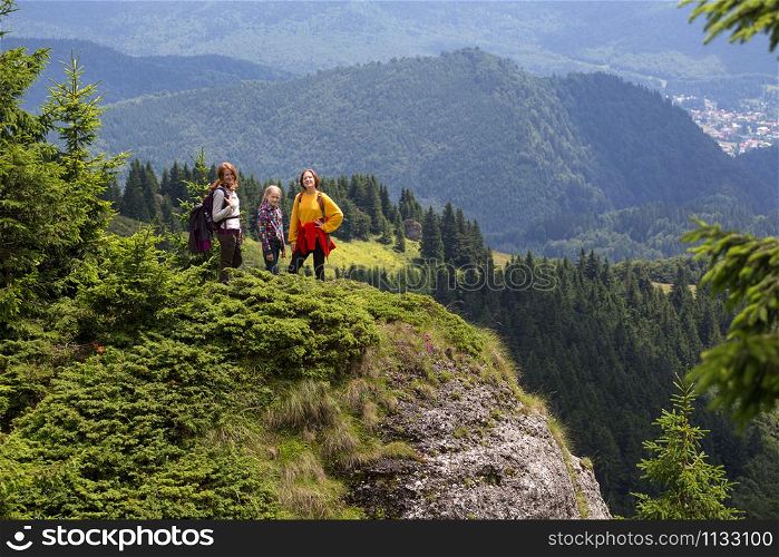 happy family in the mountains. mother with daughters are walking in the mountains