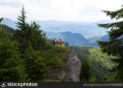 happy family in the mountains. mother with daughters are walking in the mountains