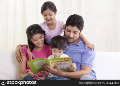 Happy family looking at book