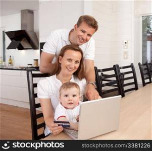 Happy family looking at the camera with a smile making an online purchase