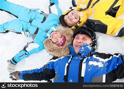 Happy family lying on a snow