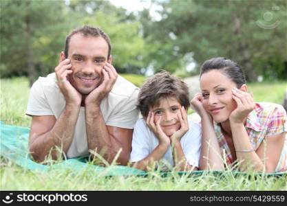 happy family lying on the grass