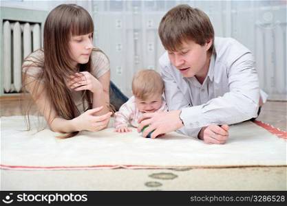 Happy family lying together and smiling indoors