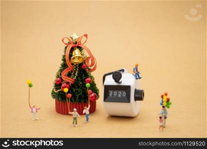 Happy Family Miniature people standing on Christmas tree Celebrate Christmas on December 25 every year. using as background xmas concept with copy spaces for you