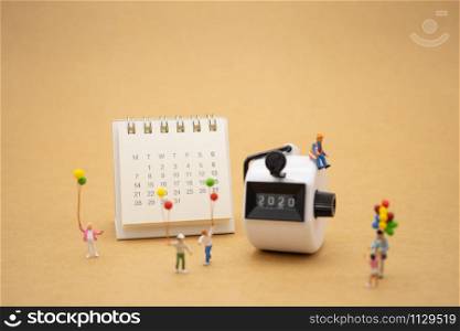 Happy Family Miniature people standing with 2020 Happy new year using as background Universal day concept and Happy new year concept with copy space for your text or design.
