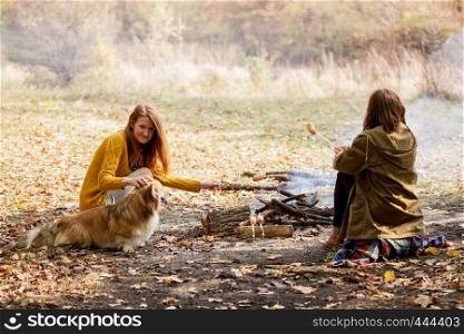 Happy family - mom and daughter on picnic in the autumn forest
