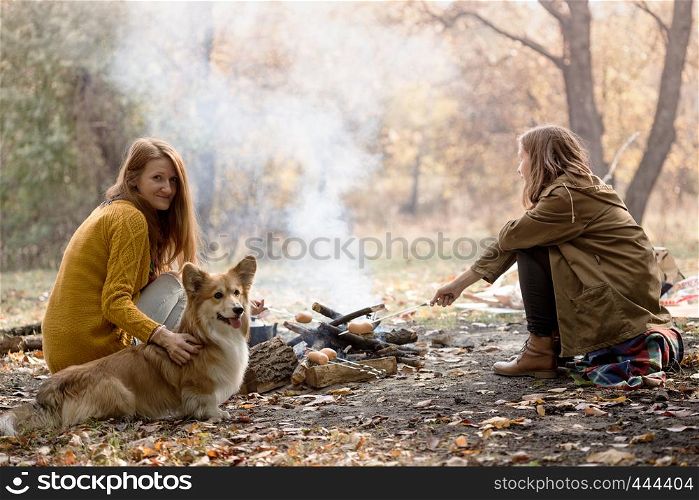 Happy family - mom and daughter on picnic in the autumn forest