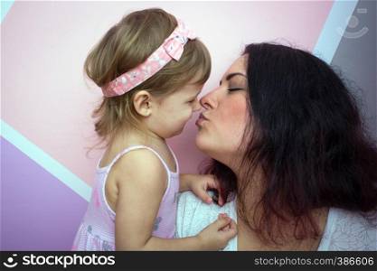 happy family - mom kisses her daughter