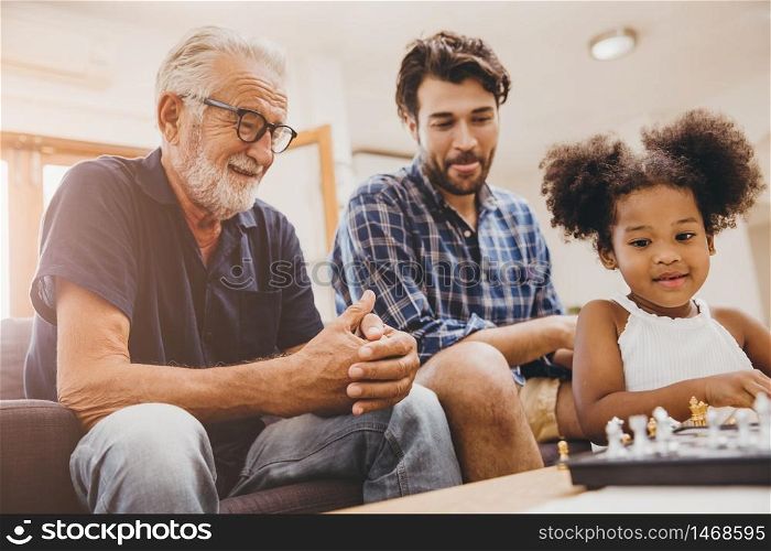 Happy family moment elder with child little girl and son at home happiness moment playing chess game.