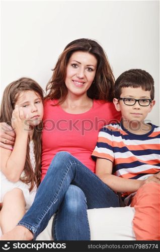 Happy family. Mother and kids on sofa at home.. Happy family. Mother woman and kids little girl and boy sitting at sofa couch at home.