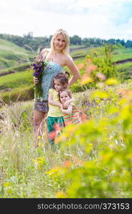 happy family - Mother and two daughters with smiling faces outdoors