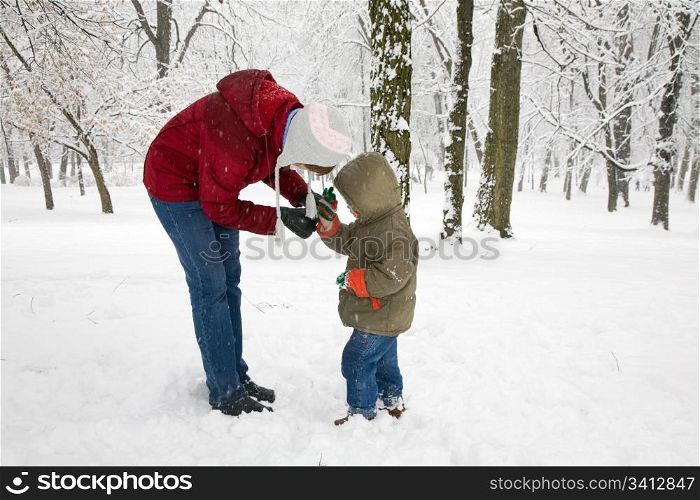 Happy family (mother with small boy) in winter city park