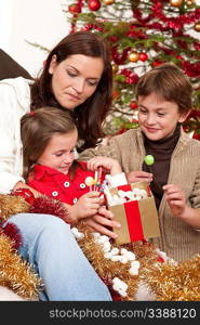 Happy family: mother with son and daughter on Christmas