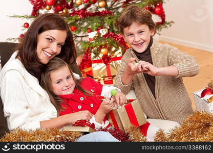 Happy family: mother with son and daughter on Christmas