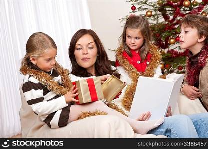 Happy family: mother with three children on Christmas