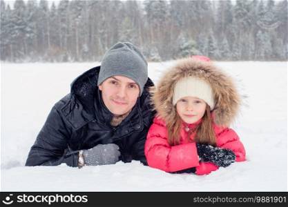 Happy family of dad and little kid playing snowballs in the winter snowy day. Happy family of dad and kid enjoy winter snowy day