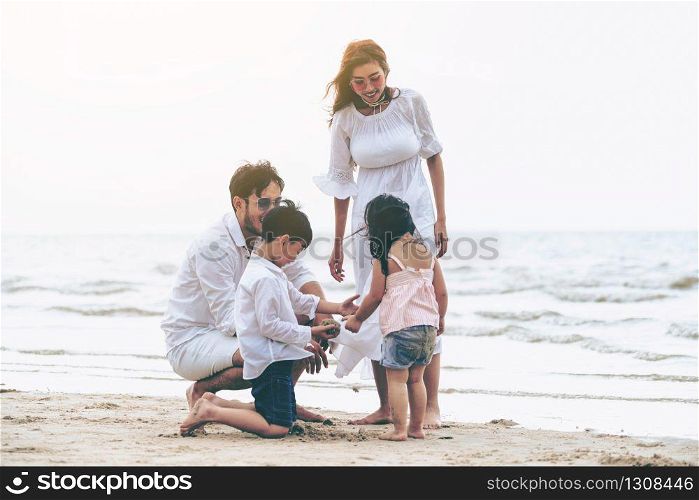 Happy family of father, mother and kids goes vacation on a tropical sand beach in summer.. Happy family goes vacation on the beach in summer.