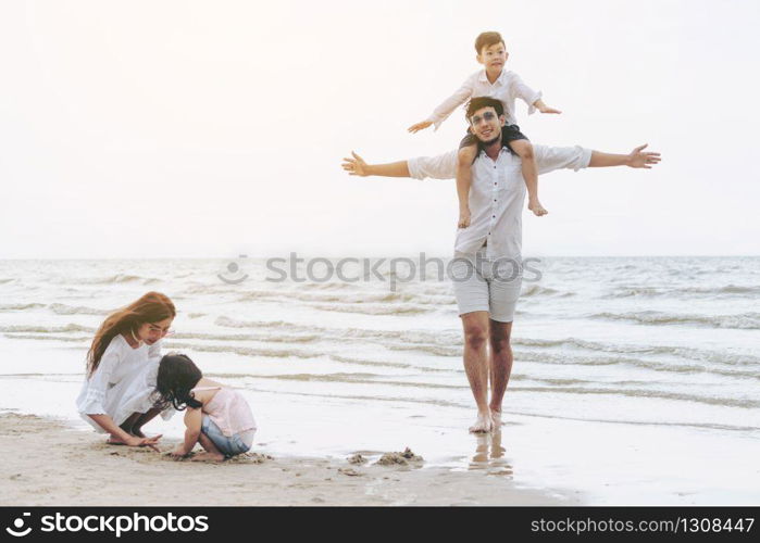 Happy family of father, mother and kids goes vacation on a tropical sand beach in summer.. Happy family goes vacation on the beach in summer.