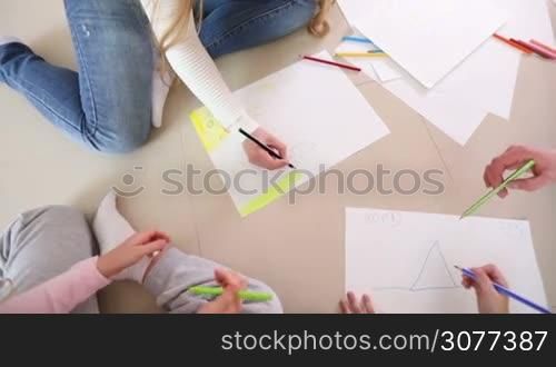 Happy family of four people drawing together at home