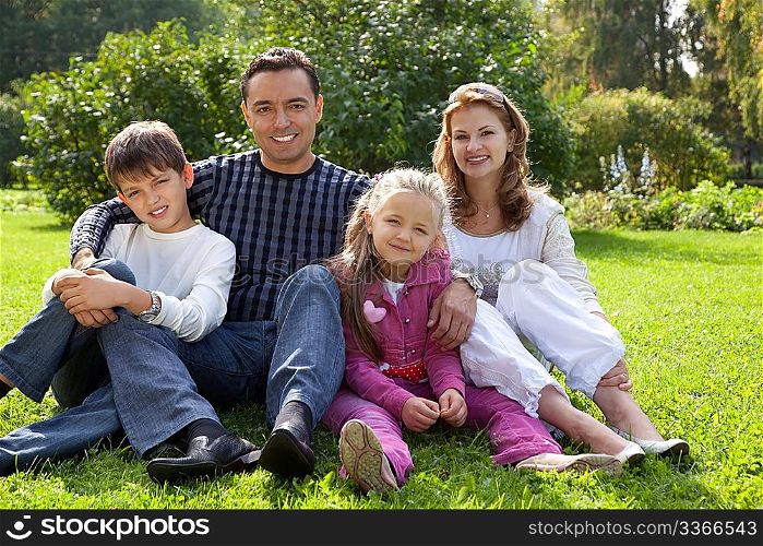 happy family of four persons outdoors