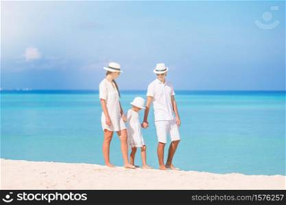 Happy family of three enjoying beach vacation. Happy family of three having fun together on the beach