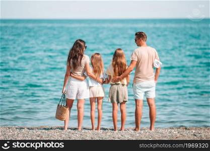 Happy family on a beach during summer vacation. Young family on vacation have a lot of fun
