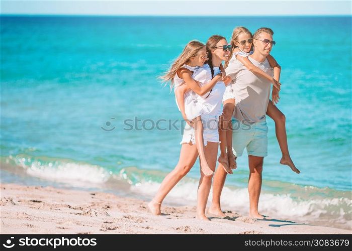 Happy family on a beach during summer vacation. Young family on vacation have a lot of fun