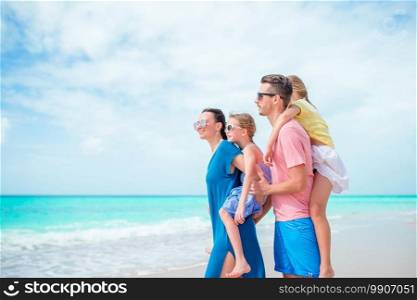 Happy family on a beach during summer vacation. Happy beautiful family on the beach on caribs