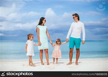 Happy family on a beach during summer vacation. Young family on summer beach vacation