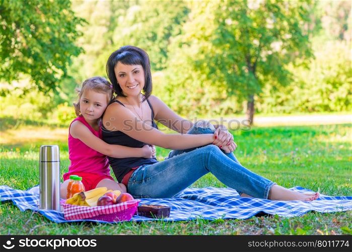 happy family on a picnic in the green lawn