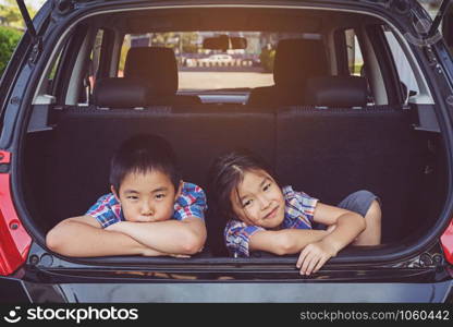 Happy family on a road trip, Sitting In Trunk Of Car