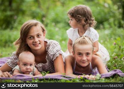 Happy family on green grass in the garden