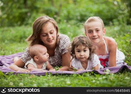 Happy family on green grass in the garden