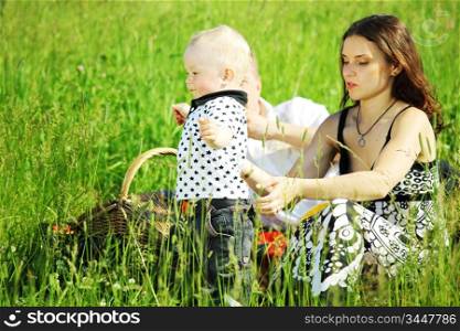 happy family on picnic in green grass